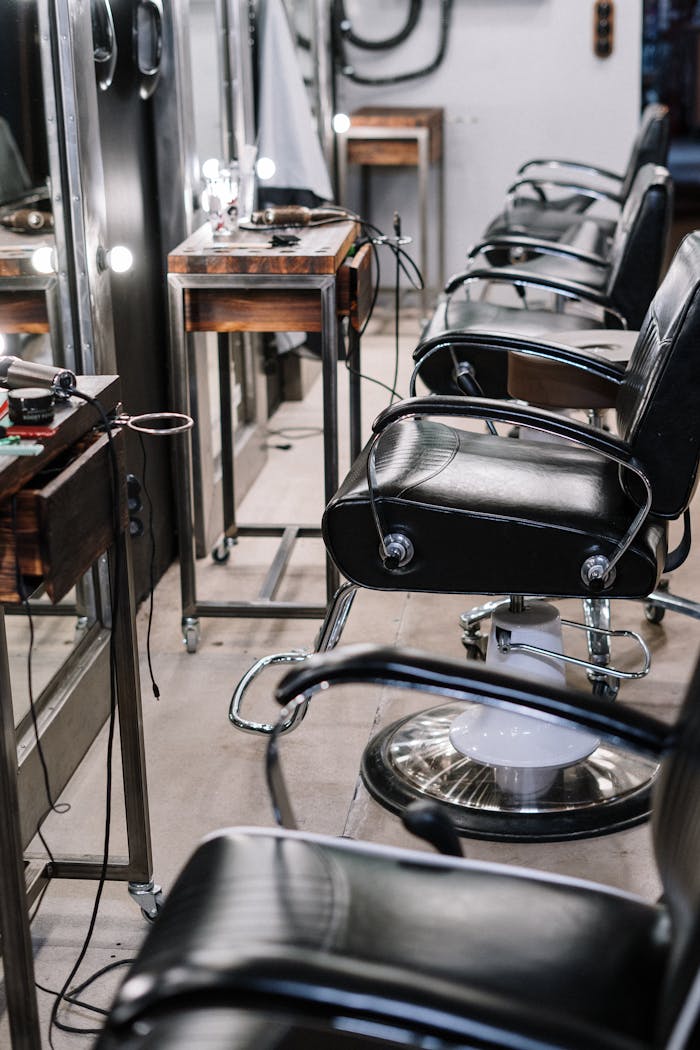 View of a contemporary hair salon with sleek chairs and mirrors, perfect for style and comfort.